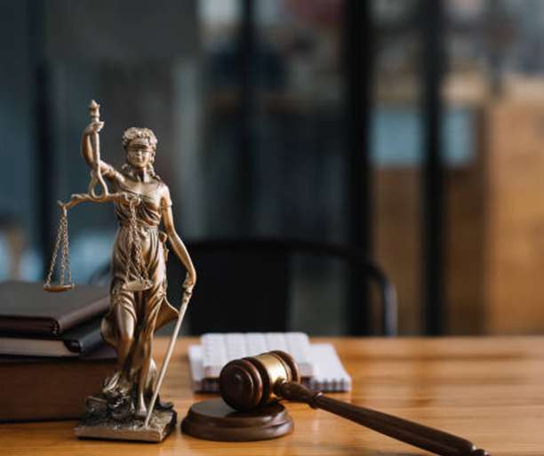 Statue of lady justice on desk of a judge or lawyer.